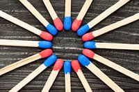 Red and blue matches on black background