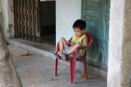 Vietnamese child playing by mathieu van wezel