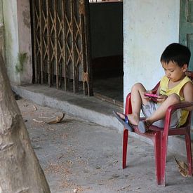 Vietnamese child playing by mathieu van wezel