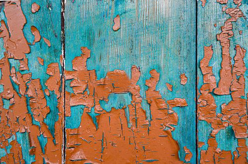 Flaking paint on a wooden panel