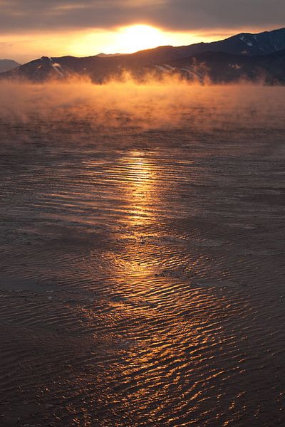Pink orange sunrise over icy lake baikal by Michael Semenov