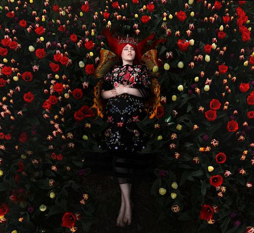 Sleeping butterfly girl among the tulips.