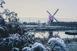 Utrecht province's smallest mill in a snowy landscape by Jos van den Berg