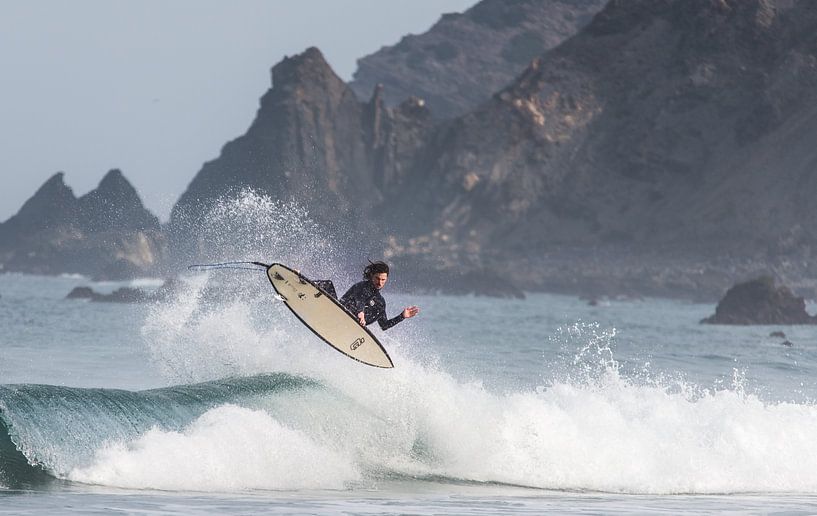 Surfer flying with cliff beackground by massimo pardini