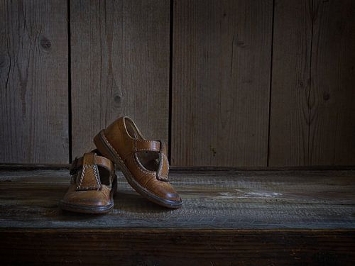 Still life with old leather children's shoes