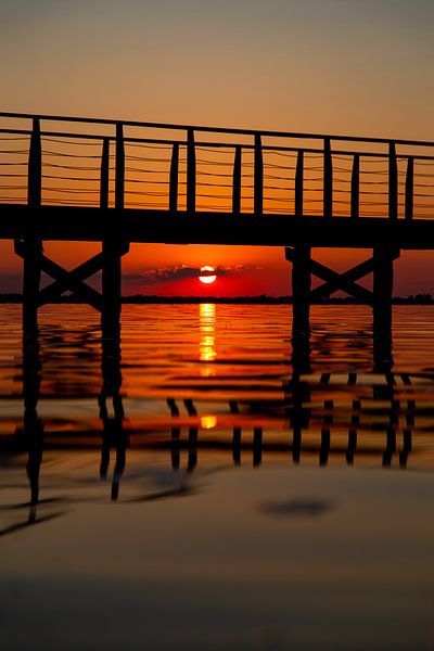 Coucher de soleil sous la jetée avec reflets dans le Lago di Lèsina par Stef Heijenk