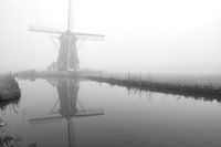 Mill in the mist on the water