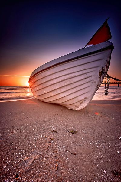 Fishing boat on the beach at sunrise on the Baltic Sea by Stefan Dinse
