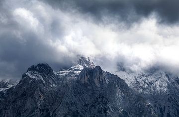 dramatic storm clouds over mountain ridge by Olha Rohulya