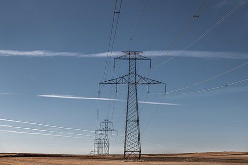 Line play with electricity pylons and cloudy sky.