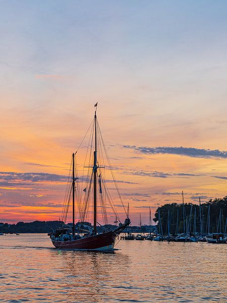 Sailing ships on the Warnow at sunset during the Hans by Rico Ködder