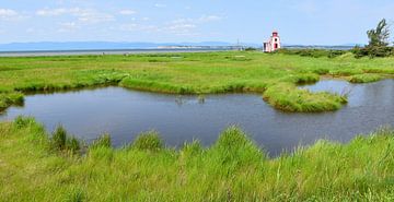The small lighthouse on the riverfront by Claude Laprise