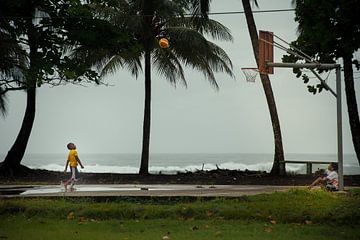 Boys play basketball next to the Caribbean Sea (Costa Rica) by Nick Hartemink