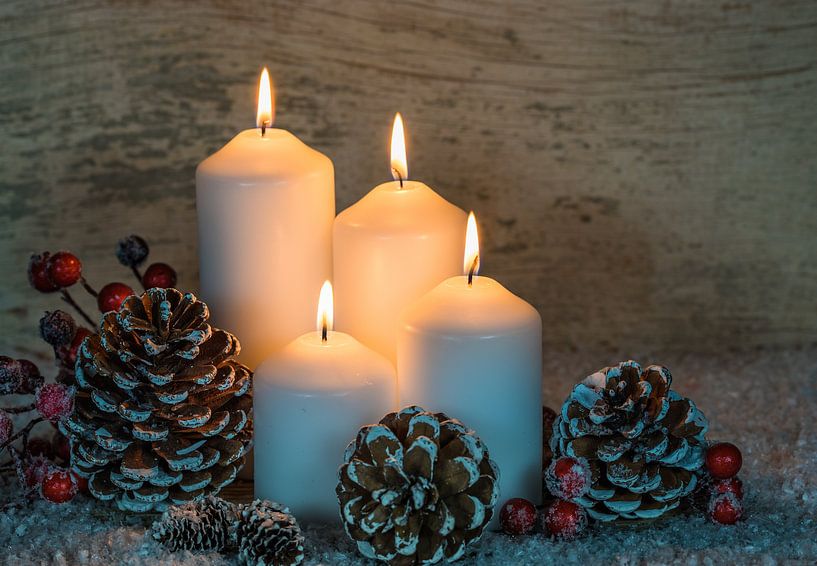 Festive Advent and Christmas candle flames with natural decoration, snow by Alex Winter