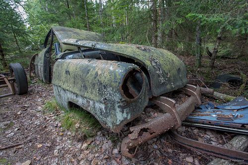 Car cemetery in forest in Ryd, Sweden