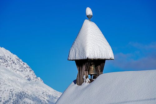 Snow-covered tower bell of a chapel on Haiminger Berg in the Tyrolean Oberland