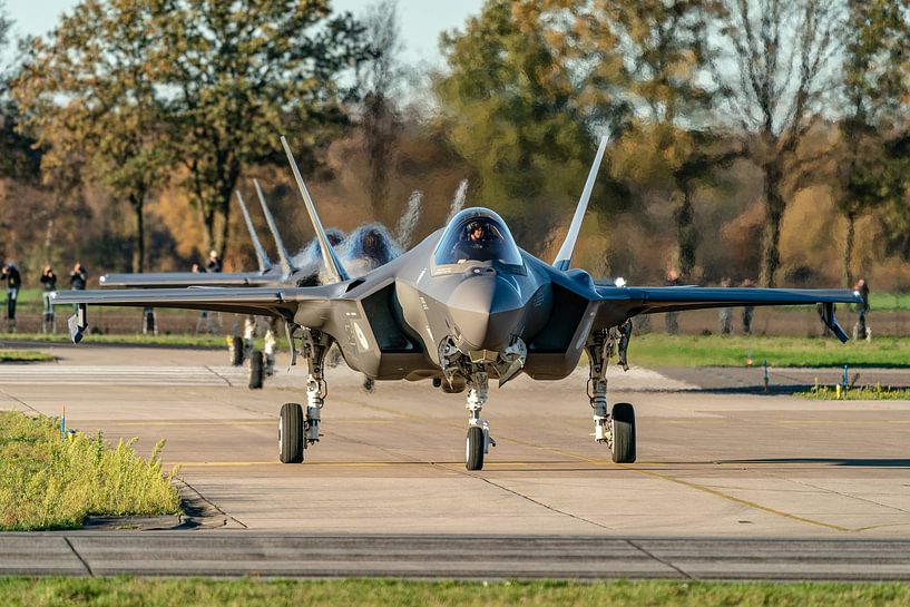 Three Lockheed Martin F-35 Lightning II aircraft are almost ready to take off for a practice flight. by Jaap van den Berg
