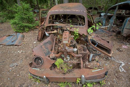 Car cemetery in forest in Ryd, Sweden