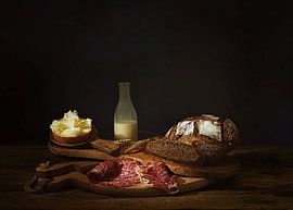 Still life with rustic bread,cheese,salami and milk.