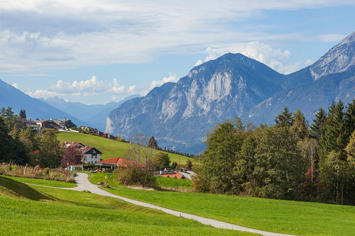 Alpine pasture, the village of Sistrans and the Karwendel Mountains 