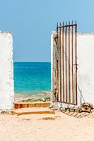 Old metal gate to the beach at the ocean in Sri Lanka