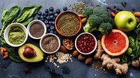 Healthy food clean eating selection: fruit, vegetable, seeds, superfood, cereals, leaf vegetable on grey copy space