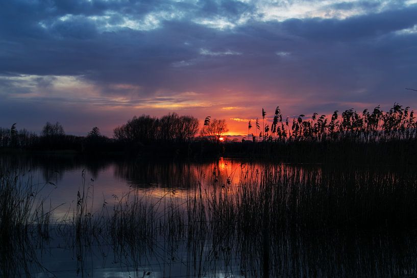 Sunset at a waterfront. by T. van der Kolk