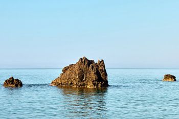 A solitary volcanic rock in the calm sea off Scalea