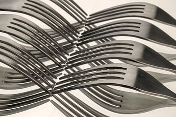 Abstract artistic photo of cutlery, i.e. forks which form a wave pattern by reflection. by Tonko Oosterink