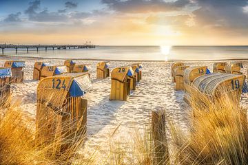 Beach chairs on the beach of the Baltic Sea at sunrise.