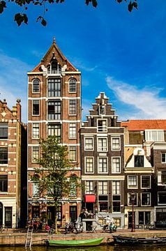 House facades and street boats on a canal canal in Amsterdam Netherlands by Dieter Walther