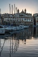 Valletta, Malta - 01 07 2022: Boats reflecting in the water at t