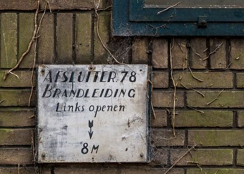 old sign on factory wall, urbex