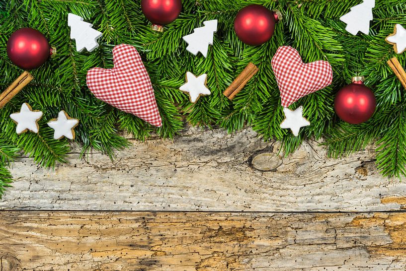 Xmas hearts and gift with ornaments and fir branches on wood background by Alex Winter