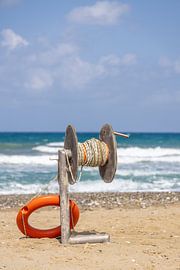 Lifebuoy with throwing device on the beach of Crete, Greece by Andreas Freund