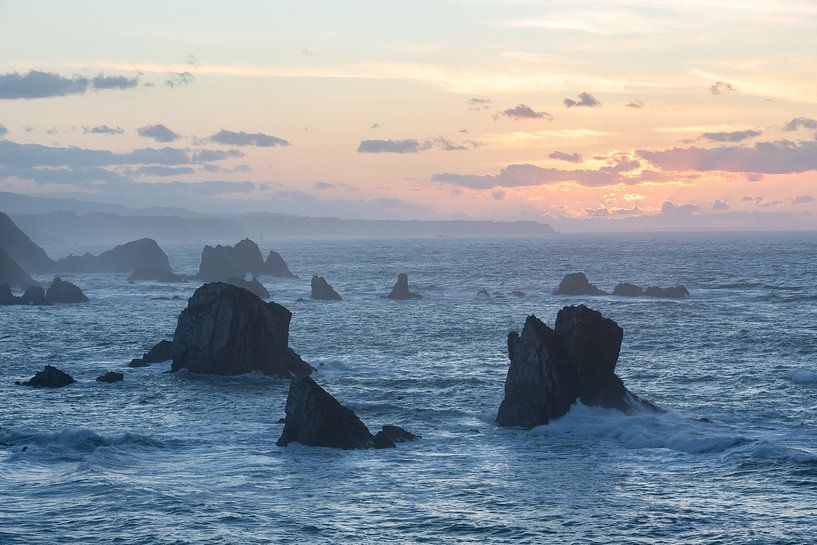 Sunset on a rugged rocky coastline by Peter Haastrecht, van