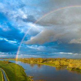 Rainbow over the river IJssel during a rainy autumn day