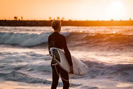 Surfer at Nørre Vorupør in Denmark by Vrijgeworteld