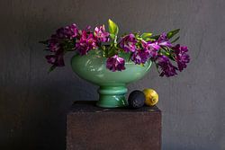 Stilleven van paarse bloemen in groene vaas