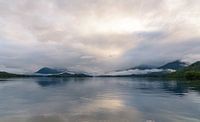 Morning mist over a calm mountain lake