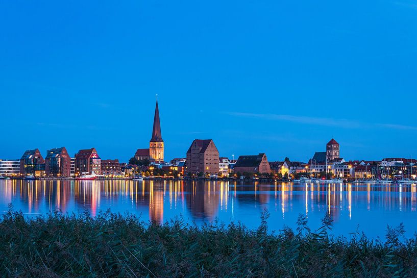 View over the Warnow River to the Hanseatic City of Rostock in the evening by Rico Ködder