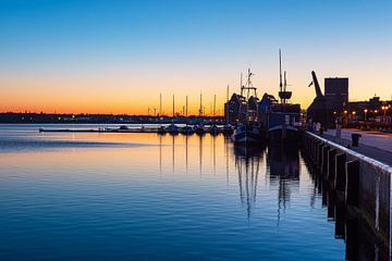 The city harbour in the early morning in the Hanseatic city of Rostock by Rico Ködder