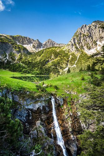 Gaisalpsee with mountain Rubihorn and waterfall near Oberstdorf in the Alps