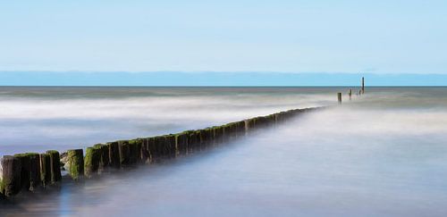 Beach poles in the surf in Zeeland.