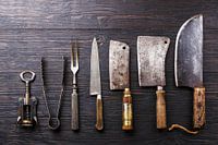 12415312 Vintage butcher's knives on wooden background