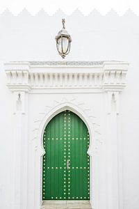Groene deur met lantaarn in Asilah in Marokko