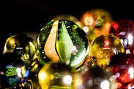 Reflected coloured glass beads on black background by Hans-Jürgen Janda thumbnail