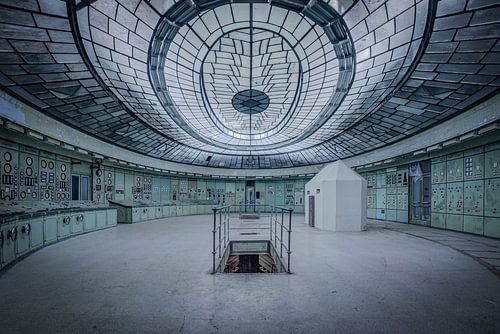 Abandoned industrial control room with glass ceiling