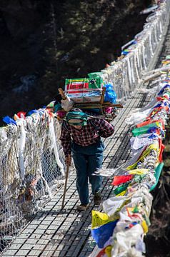 Sherpa with full pack, Nepal by Ton Tolboom