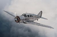 Classic airplane above the clouds